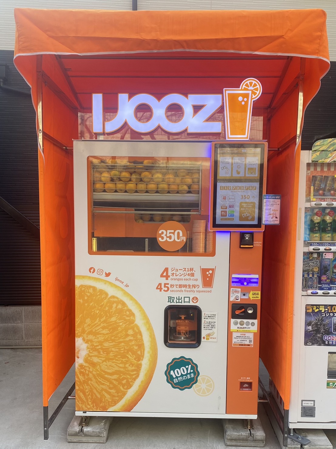 飛田新地の中にある生搾りオレンジジュース自動販売機